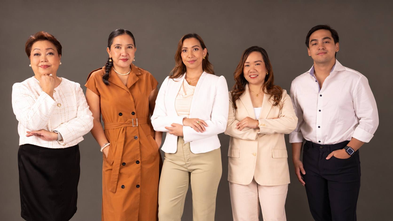 Five members of the CLEAR team standing side by side in a photo studio.